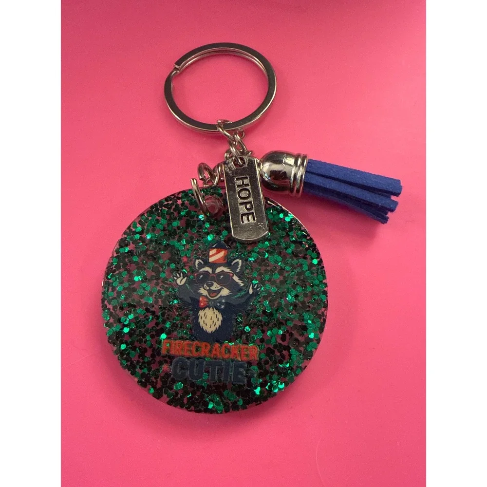 Firecracker Cutie Raccoon Keychain Green Glitter Resin Hope Charm Blue Tassel